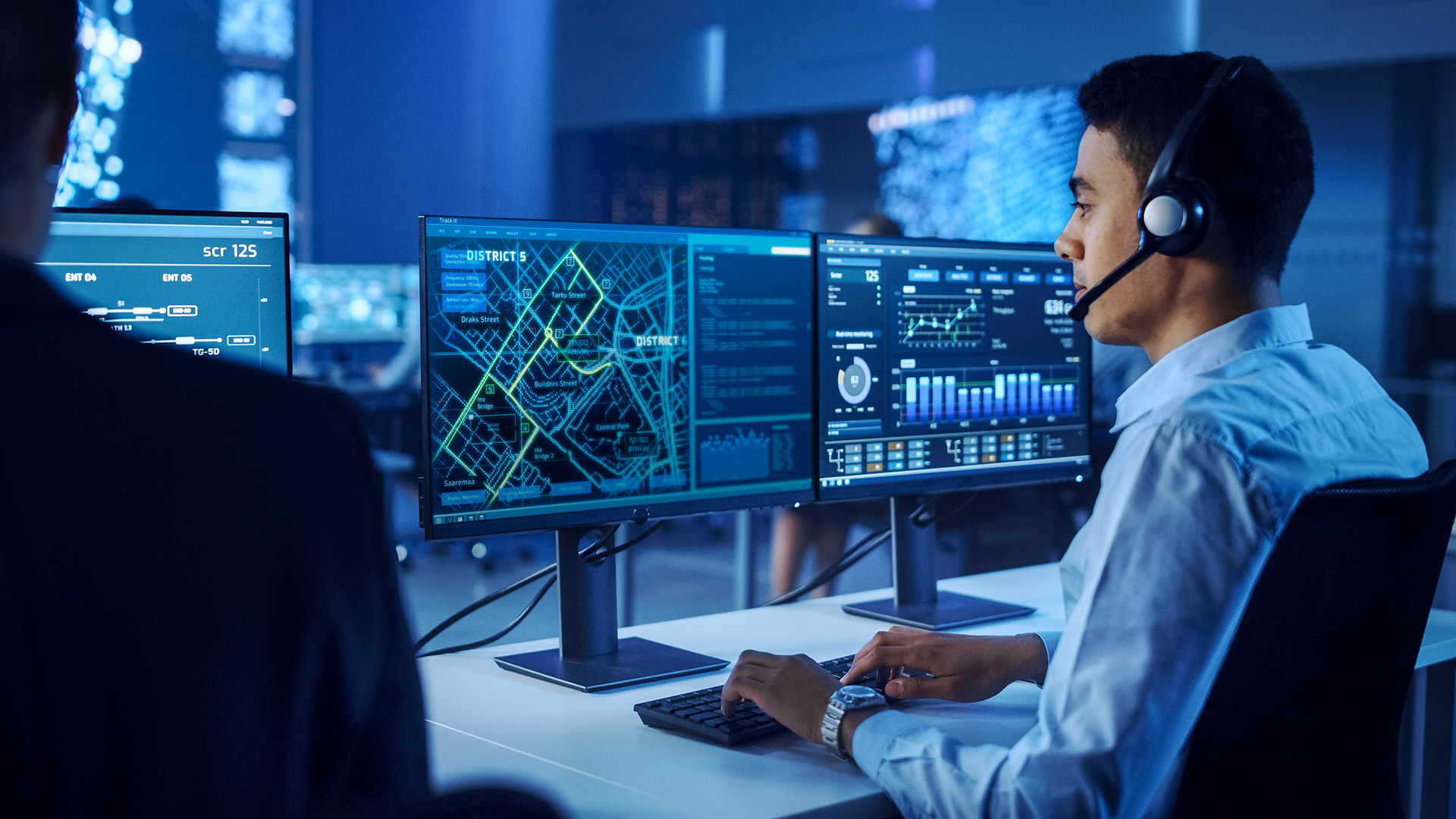 logistics worker looking over map on computer screen