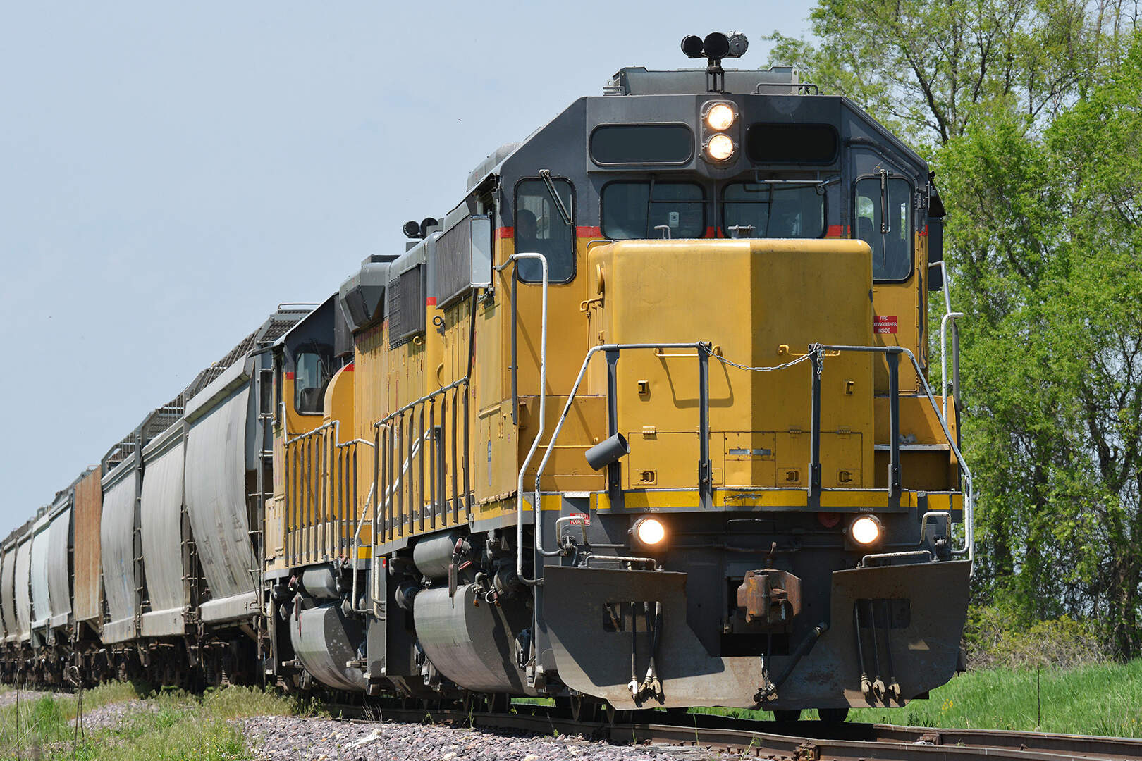 yellow train engine hauling cargo - intermodal