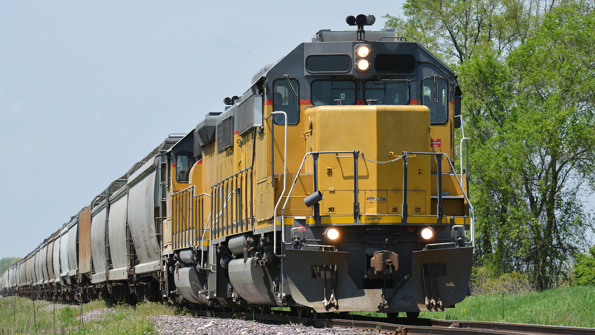 yellow train engine hauling cargo - intermodal