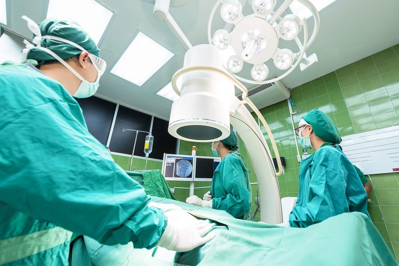 Doctors using medical equipment in a surgical room