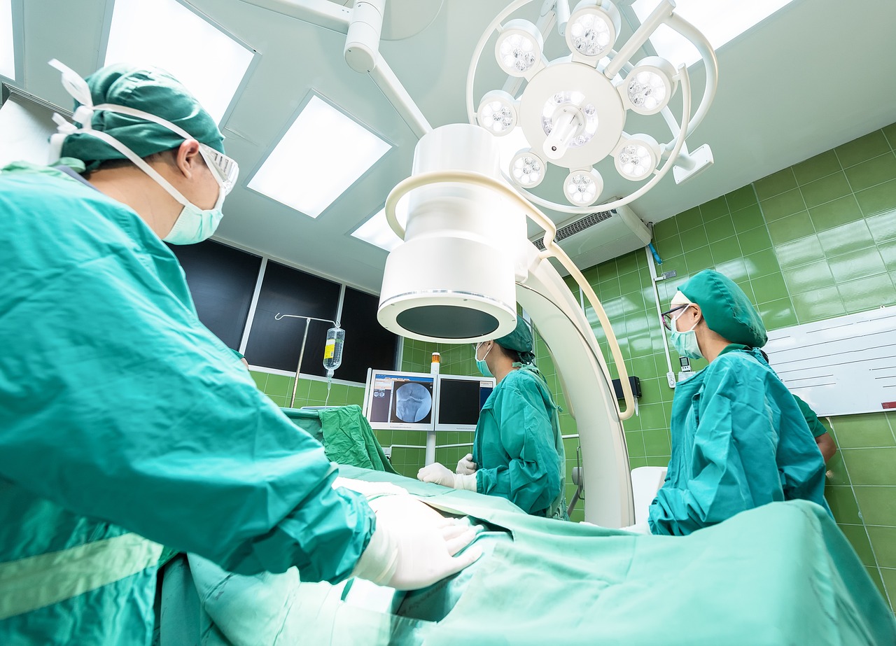 Doctors using medical equipment in a surgical room